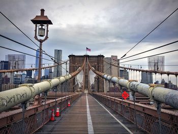 Brooklyn bridge against cloudy sky