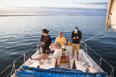 Family enjoying summer sail during golden hour