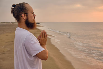 Man doing surya namaskar or salute to the sun or sun salutation