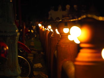 Close-up of lit candles on table