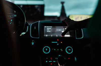 Cropped hand using illuminated control car in car