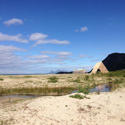 Scenic view of beach against blue sky