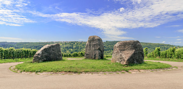 Stone wall on rock formations against sky