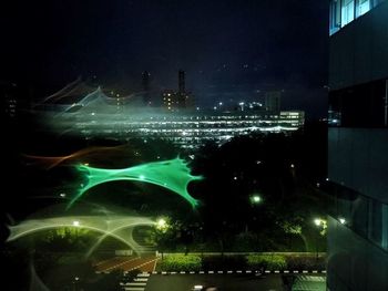 Aerial view of illuminated city against sky at night