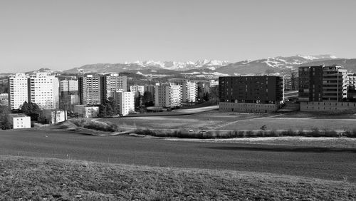 Buildings in city against clear sky