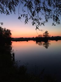 Scenic view of lake against romantic sky at sunset