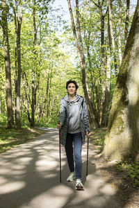 Portrait of young man standing in forest