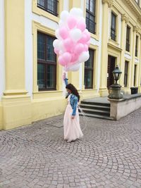 Full length of a woman standing at balloon