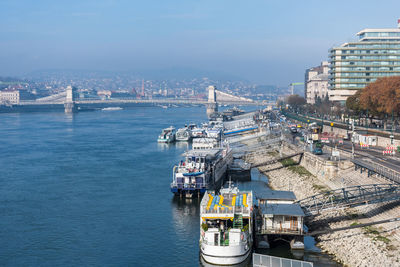 Ships and boats moored on bank of danube river in budapest, hungary