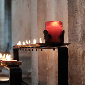 Close-up of lit candles in church