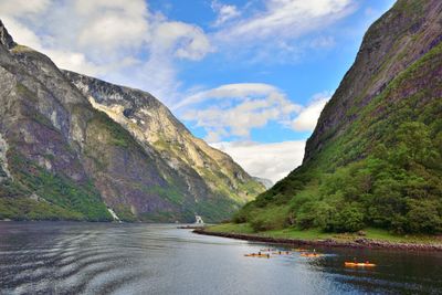 Scenic view of river amidst mountains against sky