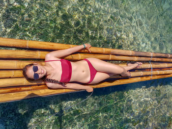 High angle view of woman lying down in swimming pool