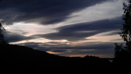 Silhouette of trees against sky at sunset