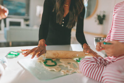 Midsection of woman preparing food at home