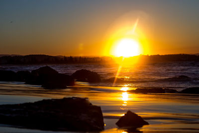 Scenic view of sea against romantic sky at sunset