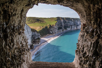 Scenic view of sea seen through arch