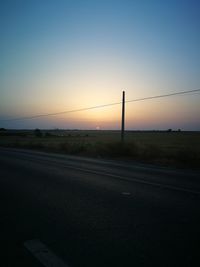 Road against clear sky during sunset
