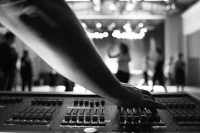 Reflection of man and woman using smart phone at music concert