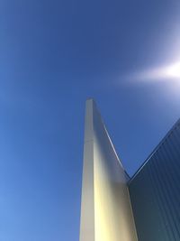 Low angle view of modern building against clear blue sky