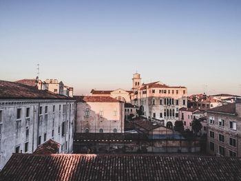 Buildings in city against clear sky