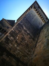 Low angle view of built structure against clear blue sky