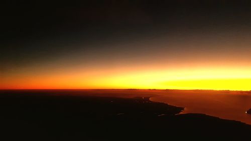 Scenic view of sea against romantic sky at sunset