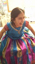 Portrait of smiling girl with multi colored face