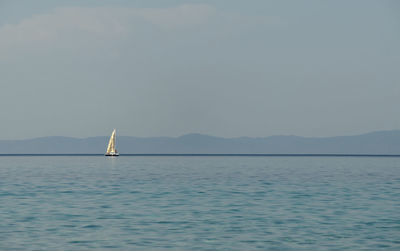 White sailing boat and aegean sea in greece