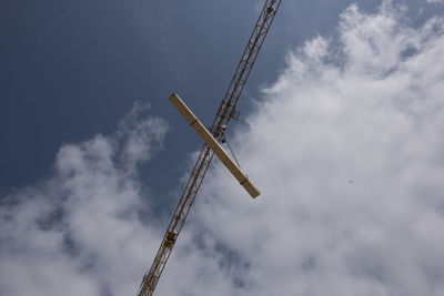 Low angle view of crane against sky