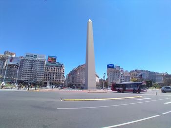 View of city street against blue sky