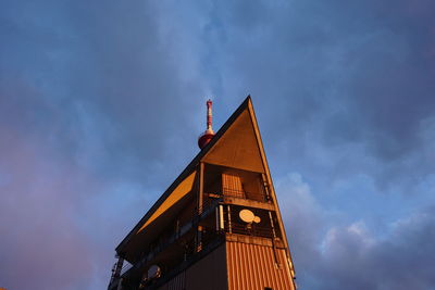 Low angle view of building against cloudy sky