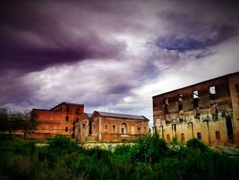 Buildings against cloudy sky