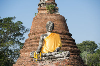 Low angle view of buddha statue at wat mahathat