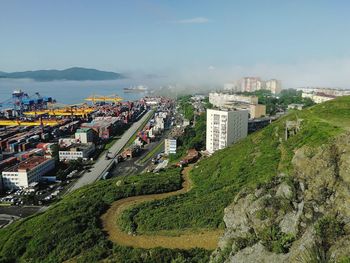 High angle view of buildings in city against foggy sky