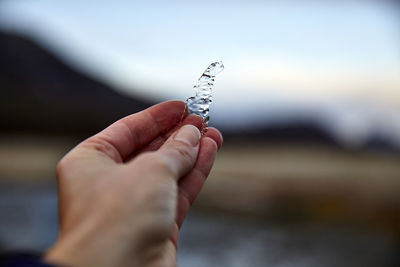 Close-up of hand holding water