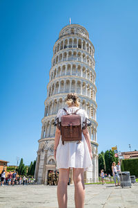 Low section of woman against clear blue sky