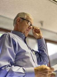 Businessman using reading glasses