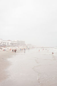 People on beach against sky