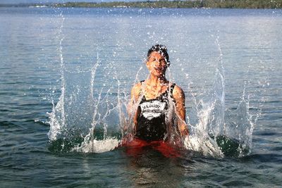 Man splashing water in sea