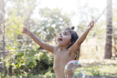 Girl playing with soap bubbles