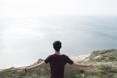 Rear view of man looking at sea