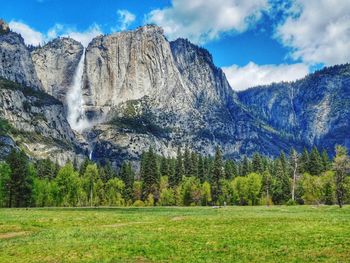 Scenic view of mountains against cloudy sky