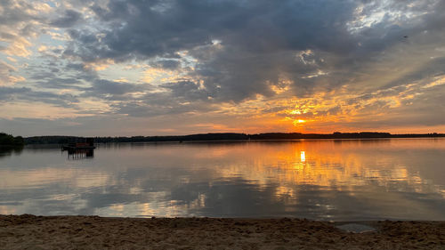 Scenic view of lake against sky during sunset