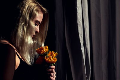 Close-up of woman holding flowers