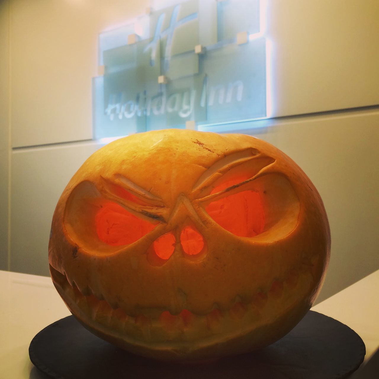 CLOSE-UP OF PUMPKIN AGAINST TABLE