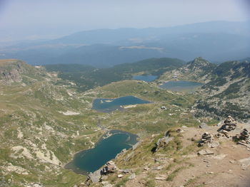 Scenic view of sea and mountains against sky