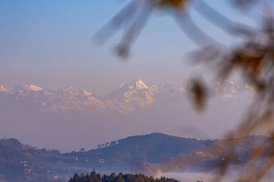 Woman on mountain range against sky