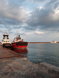 Ship moored on sea against sky