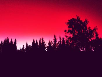 Silhouette trees against sky during sunset