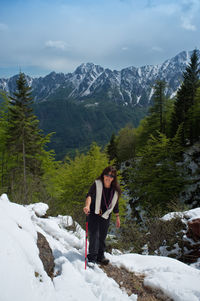 Portrait of man standing on snow covered mountains